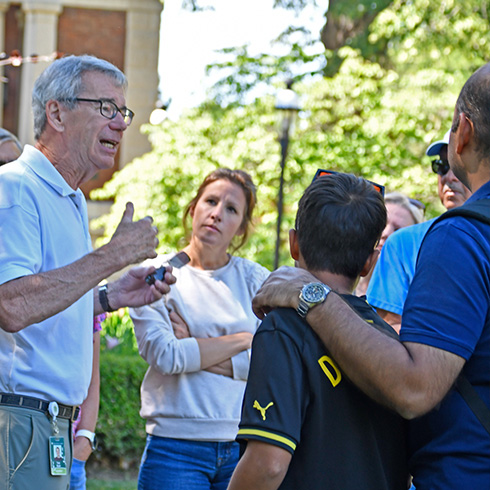 Guide leading tour in garden setting